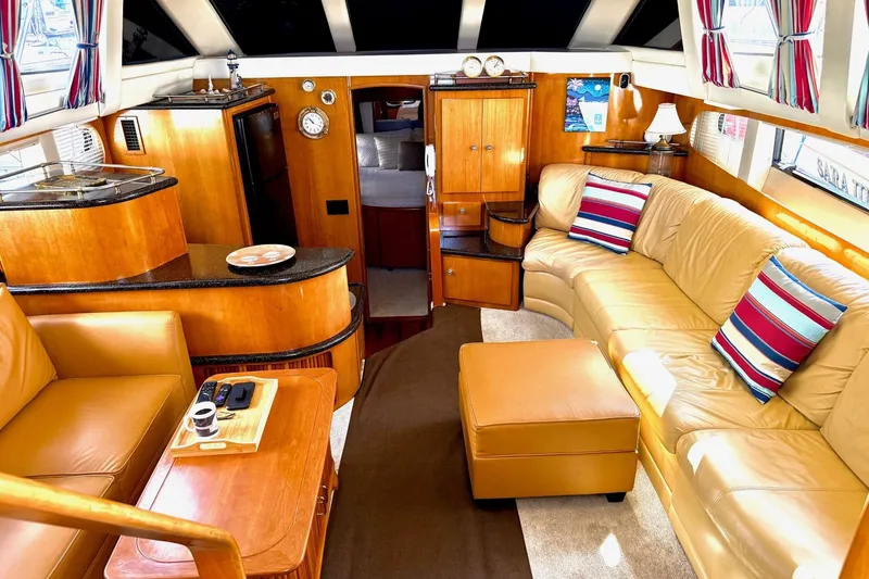 Slide: The Image of Luxurious interior of 2001 Carver 444 Cockpit Motor Yacht with leather seating and wood finishes. - 23