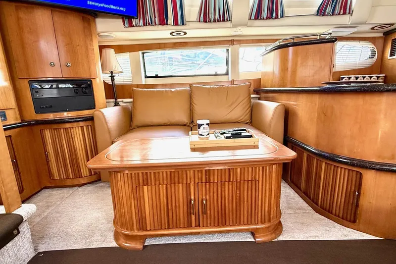 Slide: The Image of Interior of 2001 Carver 444 Cockpit Motor Yacht with wooden cabinetry and leather seating. - 26