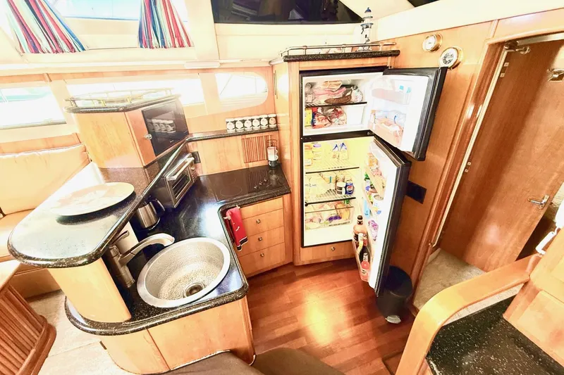 Slide: The Image of Luxurious kitchen interior of 2001 Carver 444 Cockpit Motor Yacht with open fridge. - 28
