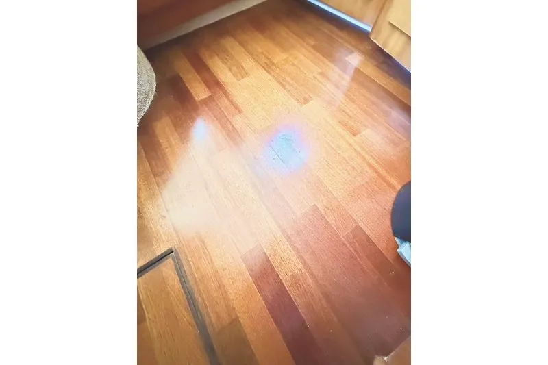 Slide: The Image of Polished wooden floor inside a 2001 Carver 444 Cockpit Motor Yacht. - 29