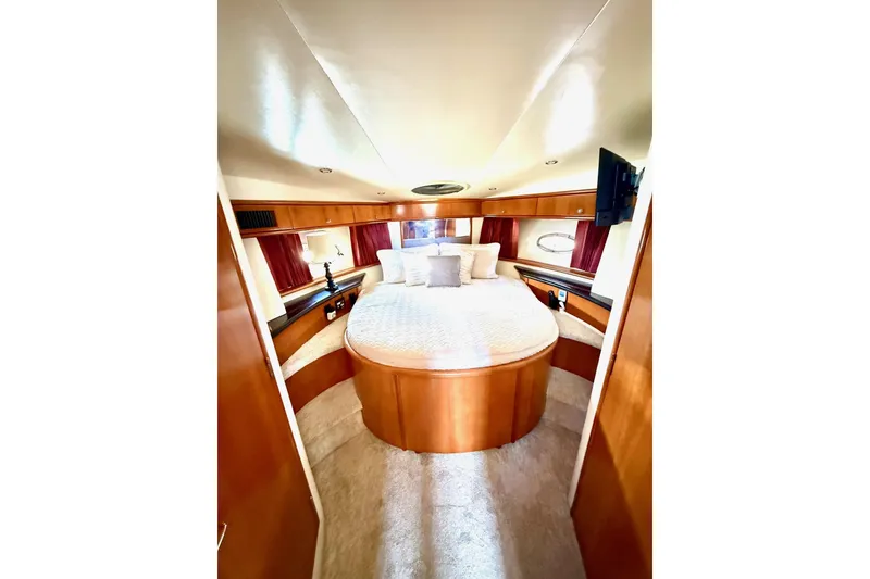 Slide: The Image of Luxurious bedroom interior of 2001 Carver 444 Cockpit Motor Yacht with elegant wood finishes. - 33