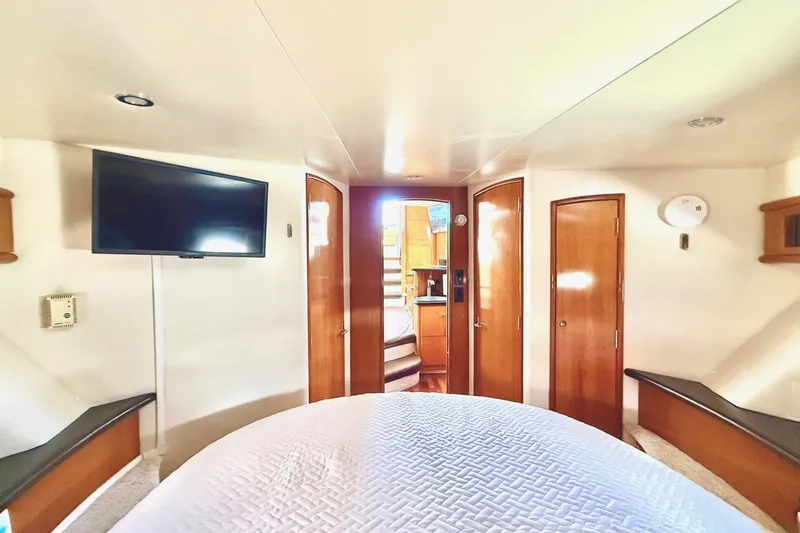 Slide: The Image of Luxurious interior of 2001 Carver 444 Cockpit Motor Yacht with TV and wooden accents. - 34