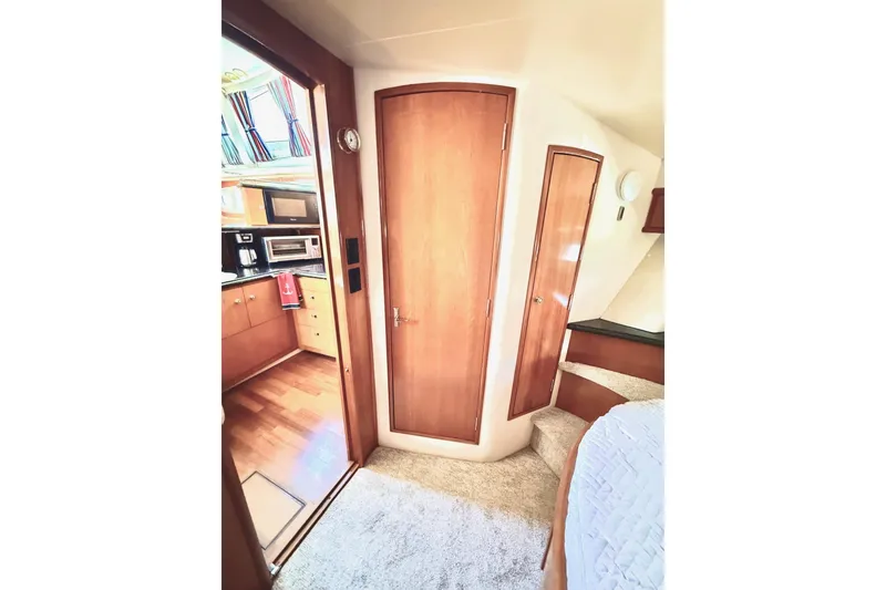 Slide: The Image of Interior of 2001 Carver 444 Cockpit Motor Yacht, featuring wood cabinetry and cozy living space. - 35