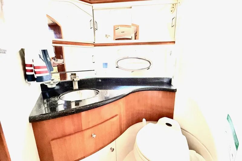 Slide: The Image of Luxurious bathroom in 2001 Carver 444 Cockpit Motor Yacht with modern fixtures and wood accents. - 36