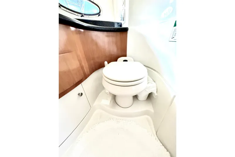 Slide: The Image of Bathroom interior of 2001 Carver 444 Cockpit Motor Yacht, featuring a compact toilet. - 37