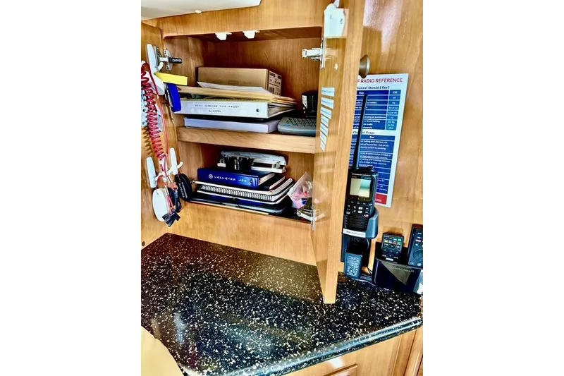 Slide: The Image of Interior storage of 2001 Carver 444 Cockpit Motor Yacht with shelves and communication devices. - 40