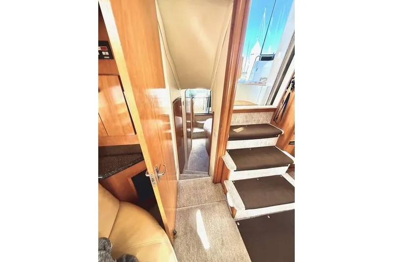 Slide: The Image of Interior view of 2001 Carver 444 Cockpit Motor Yacht, featuring stairs and wooden cabinetry. - 41