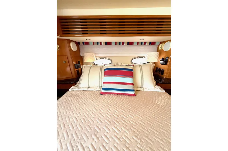 Slide: The Image of Luxurious bedroom interior of 2001 Carver 444 Cockpit Motor Yacht with striped pillows. - 43