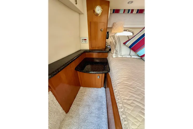 Slide: The Image of Interior of 2001 Carver 444 Cockpit Motor Yacht with cozy bed and wooden cabinetry. - 45