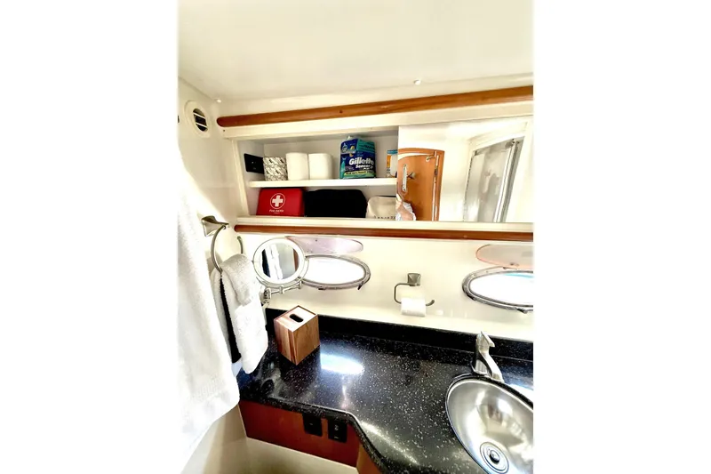 Slide: The Image of Bathroom interior of 2001 Carver 444 Cockpit Motor Yacht with sink and storage shelves. - 48