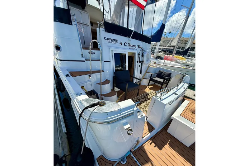 Slide: The Image of 2001 Carver 444 Cockpit Motor Yacht docked, featuring spacious aft cockpit seating area just outside the master cabin perfect for morning coffee. - 5