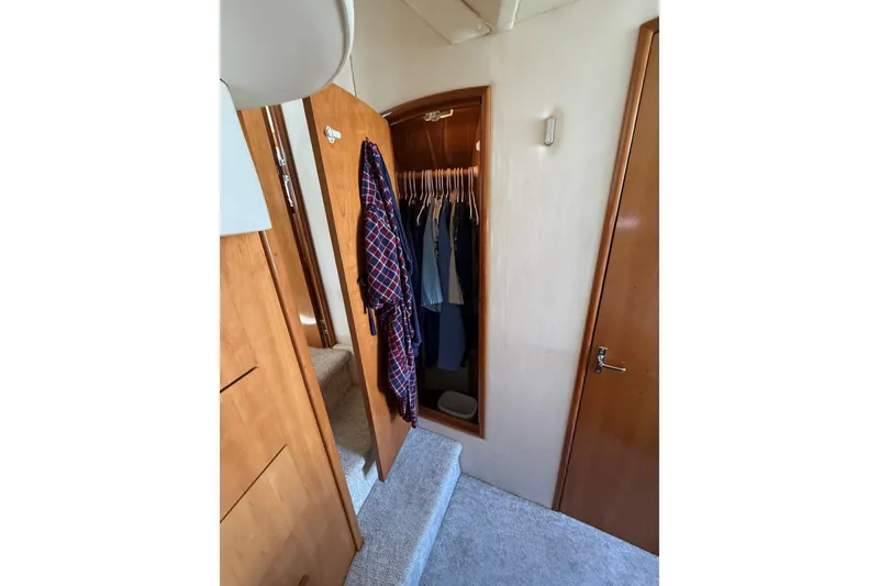 Slide: The Image of Interior of 2001 Carver 444 Cockpit Motor Yacht with open closet and hanging clothes. - 51