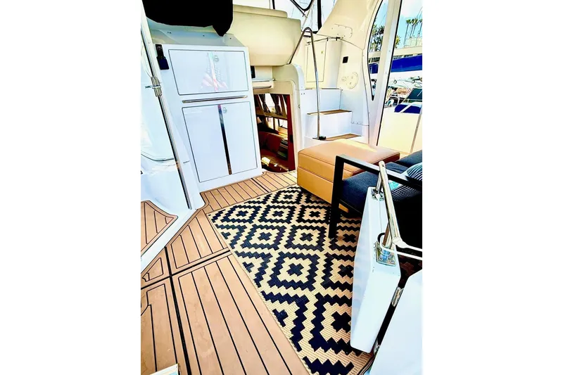 Slide: The Image of Interior of 2001 Carver 444 Cockpit Motor Yacht with patterned rug and modern furnishings. - 8