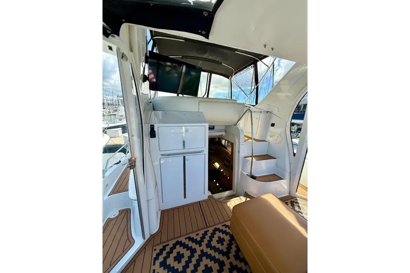 Slide: The Image of Interior view of 2001 Carver 444 Cockpit Motor Yacht with stairs and seating area. - 9
