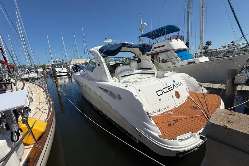 Slide: The Image of 2008 Sea Ray 38 Sundancer yacht docked at marina, featuring sleek design and spacious deck. - 33
