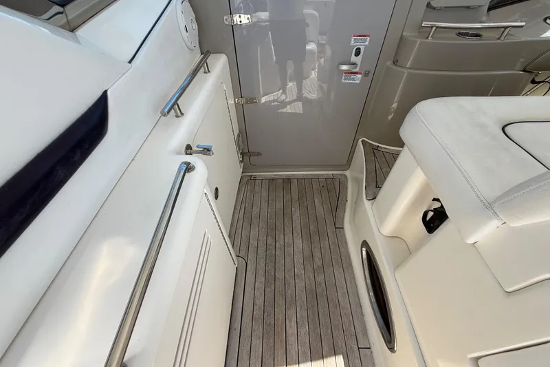 Slide: The Image of 2008 Sea Ray 38 Sundancer cockpit with teak flooring and white seating. - 100