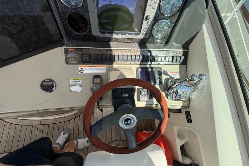 Slide: The Image of Cockpit view of 2008 Sea Ray 38 Sundancer with steering wheel and control panel. - 108
