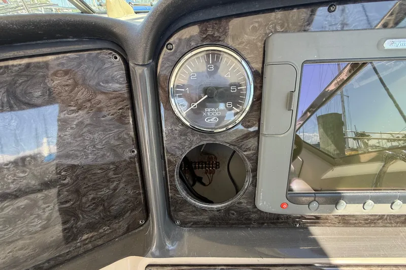 Slide: The Image of Dashboard of a 2008 Sea Ray 38 Sundancer boat with RPM gauge and navigation screen. - 109