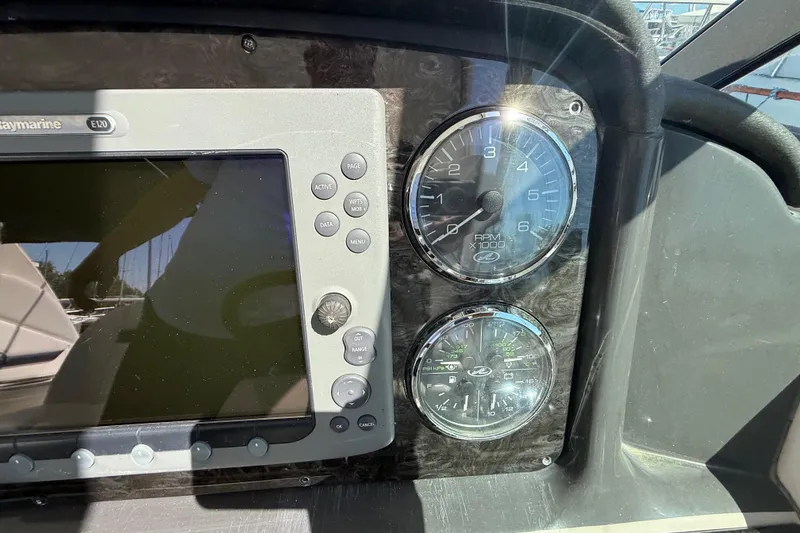 Slide: The Image of Dashboard of a 2008 Sea Ray 38 Sundancer with gauges and navigation display. - 110