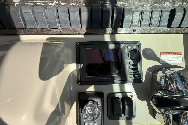 Slide: The Image of Control panel of a 2008 Sea Ray 38 Sundancer boat with switches and display. - 111