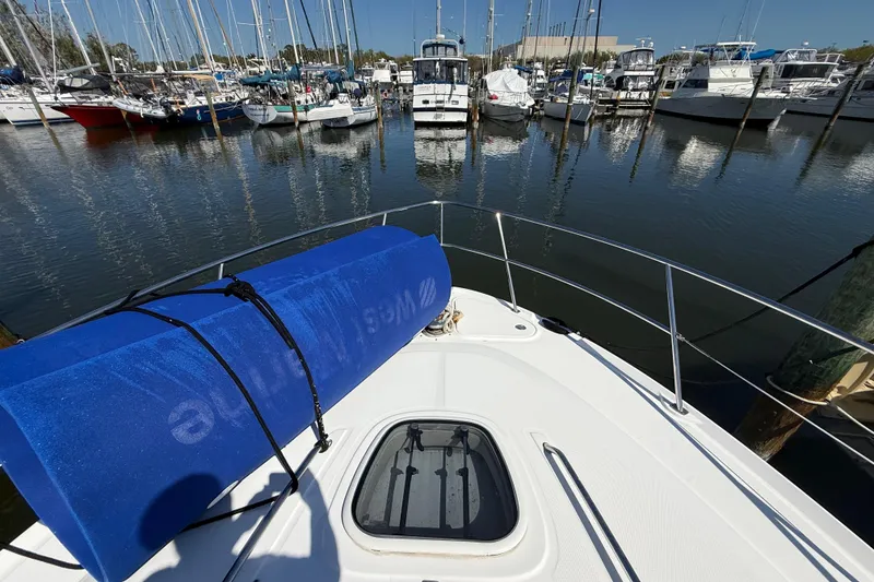 Slide: The Image of Bow view of 2008 Sea Ray 38 Sundancer in a marina with boats. - 12