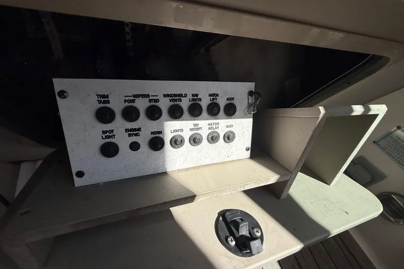 Slide: The Image of Control panel of a 2008 Sea Ray 38 Sundancer boat with various switches. - 122