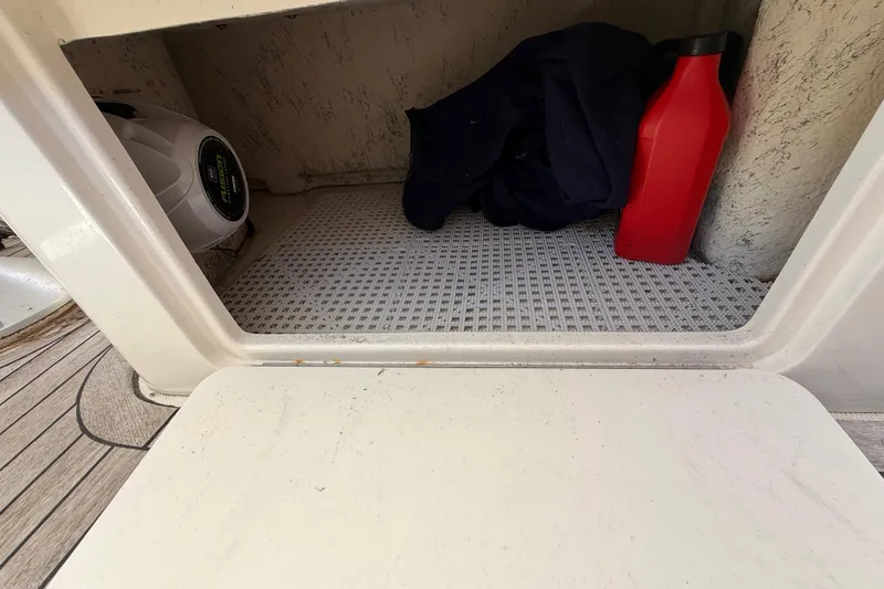 Slide: The Image of Storage compartment on a 2008 Sea Ray 38 Sundancer boat with items inside. - 123