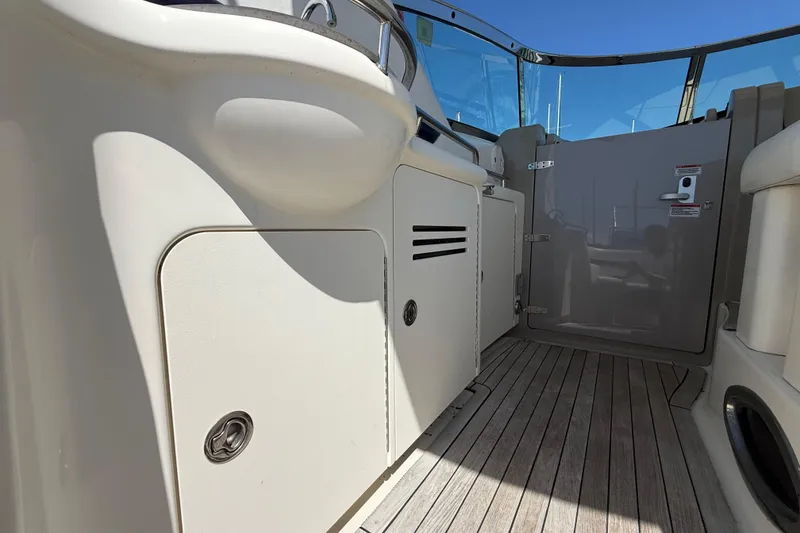 Slide: The Image of 2008 Sea Ray 38 Sundancer cockpit with teak flooring and sleek cabinetry. - 124