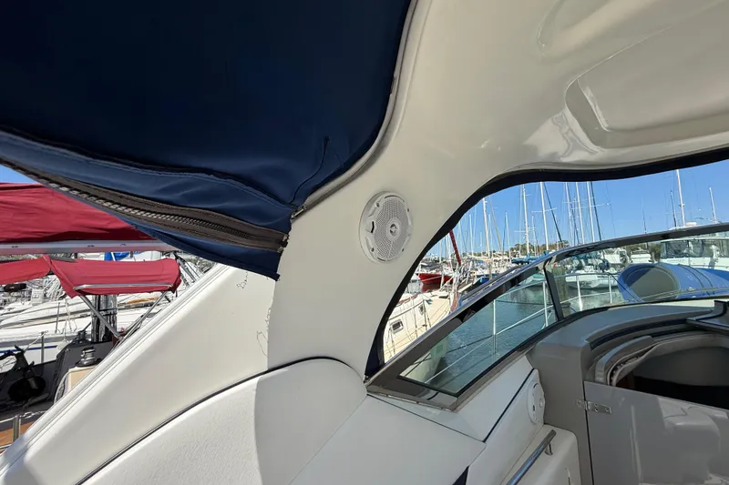 Slide: The Image of 2008 Sea Ray 38 Sundancer interior with blue canopy and marina view. - 126