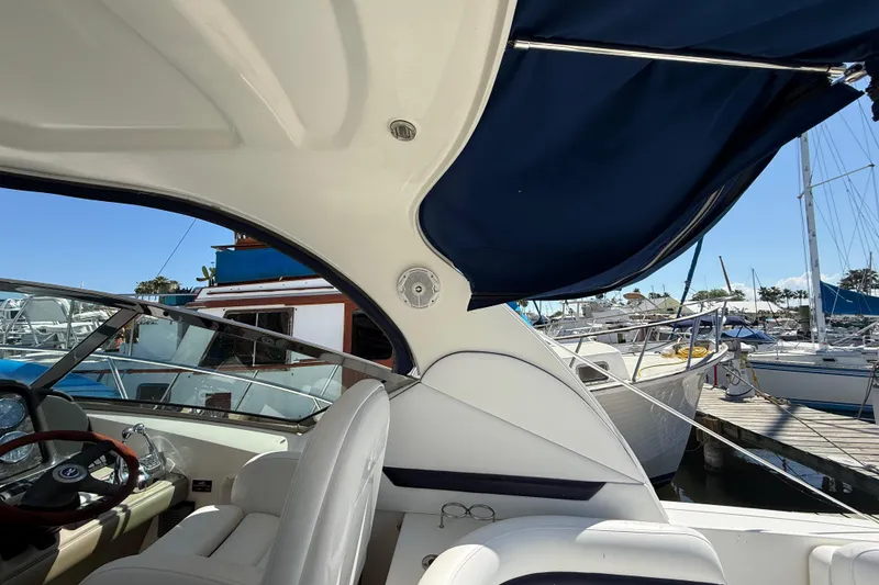 Slide: The Image of 2008 Sea Ray 38 Sundancer yacht interior with marina view, featuring helm and seating area. - 131