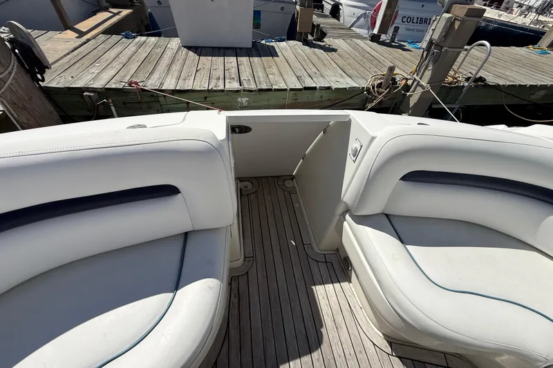 Slide: The Image of 2008 Sea Ray 38 Sundancer boat interior with white seating and wooden deck. - 136