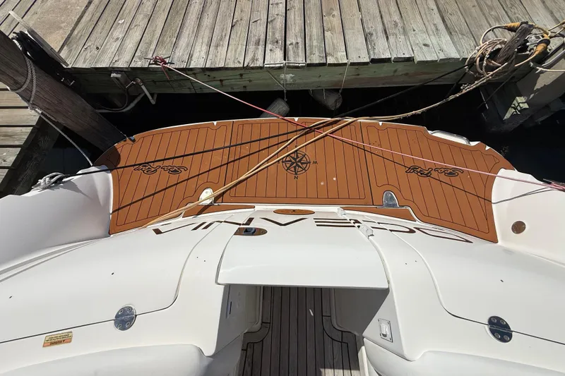 Slide: The Image of 2008 Sea Ray 38 Sundancer docked, showcasing teak swim platform and nautical compass design. - 140