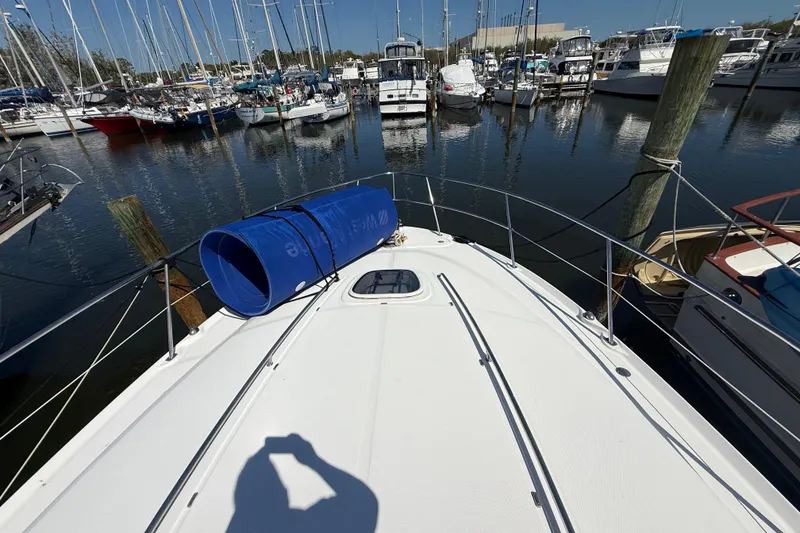 Slide: The Image of 2008 Sea Ray 38 Sundancer yacht docked in marina, surrounded by boats. - 15