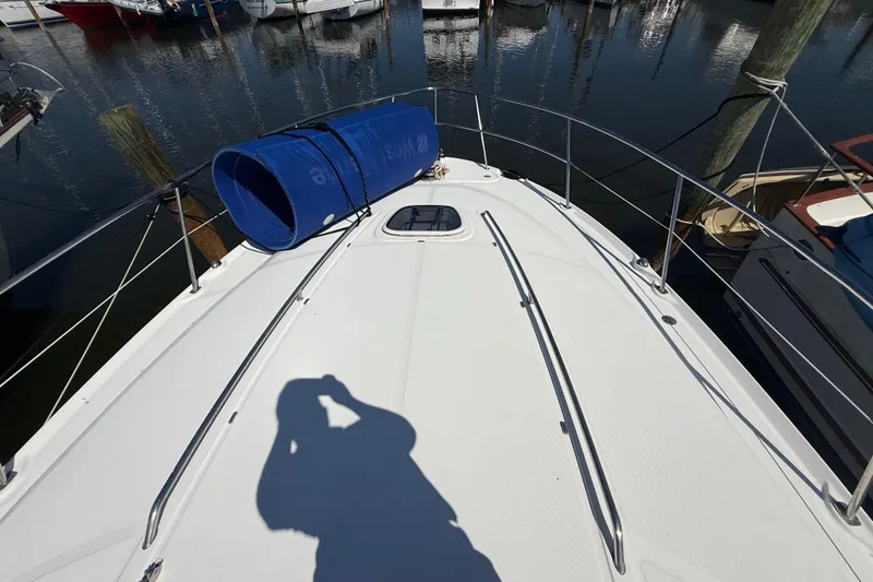 Slide: The Image of 2008 Sea Ray 38 Sundancer yacht deck with blue cover, docked at marina. - 16