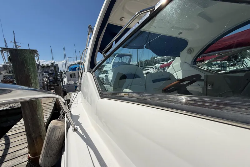 Slide: The Image of 2008 Sea Ray 38 Sundancer yacht docked at marina under clear blue sky. - 18