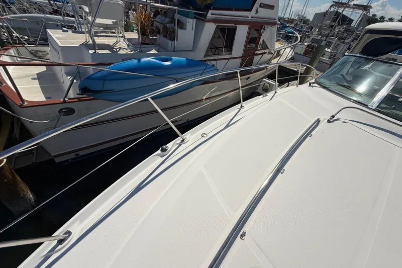 Slide: The Image of 2008 Sea Ray 38 Sundancer yacht docked at marina, featuring sleek deck design. - 2