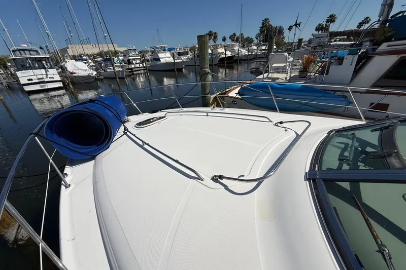 Slide: The Image of 2008 Sea Ray 38 Sundancer yacht docked at marina, surrounded by other boats. - 21