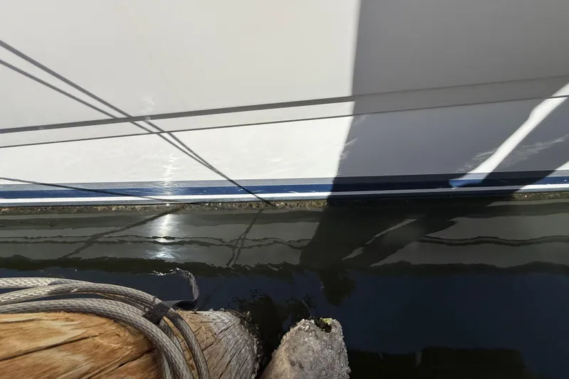 Slide: The Image of Side view of a 2008 Sea Ray 38 Sundancer yacht docked by wooden posts. - 30