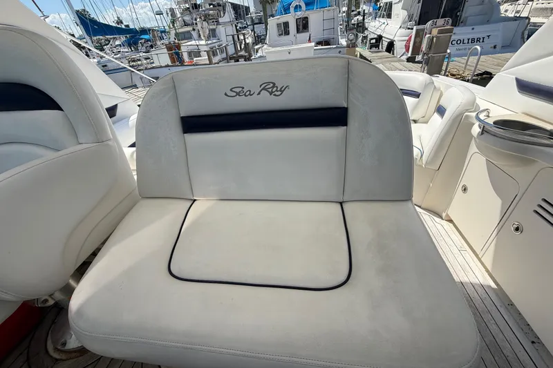 Slide: The Image of 2008 Sea Ray 38 Sundancer boat seating area with marina background. - 32