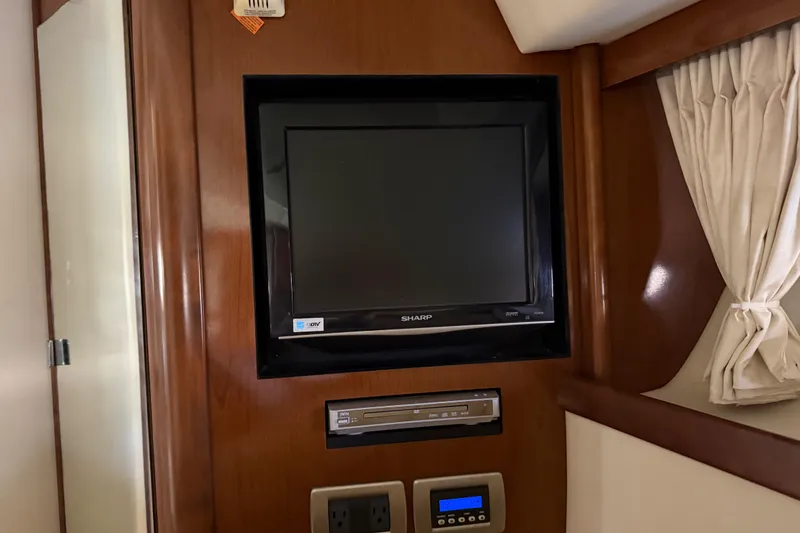 Slide: The Image of Entertainment system in 2008 Sea Ray 38 Sundancer yacht interior with TV and DVD player. - 43