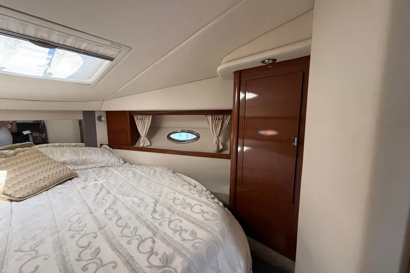 Slide: The Image of Luxurious cabin interior of 2008 Sea Ray 38 Sundancer yacht with elegant bedding and wood accents. - 48