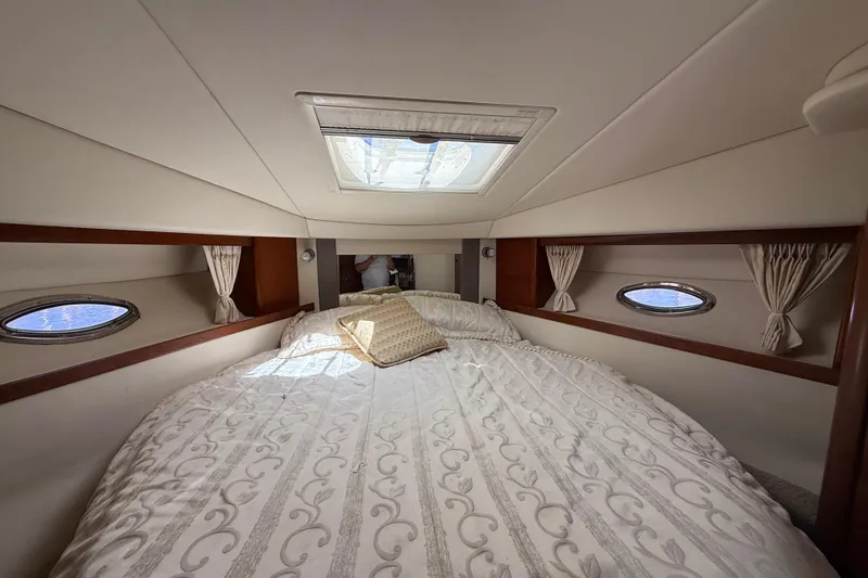 Slide: The Image of Luxurious cabin interior of 2008 Sea Ray 38 Sundancer yacht with skylight and elegant bedding. - 49