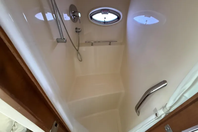 Slide: The Image of Shower area inside 2008 Sea Ray 38 Sundancer yacht, featuring modern fixtures and porthole window. - 56