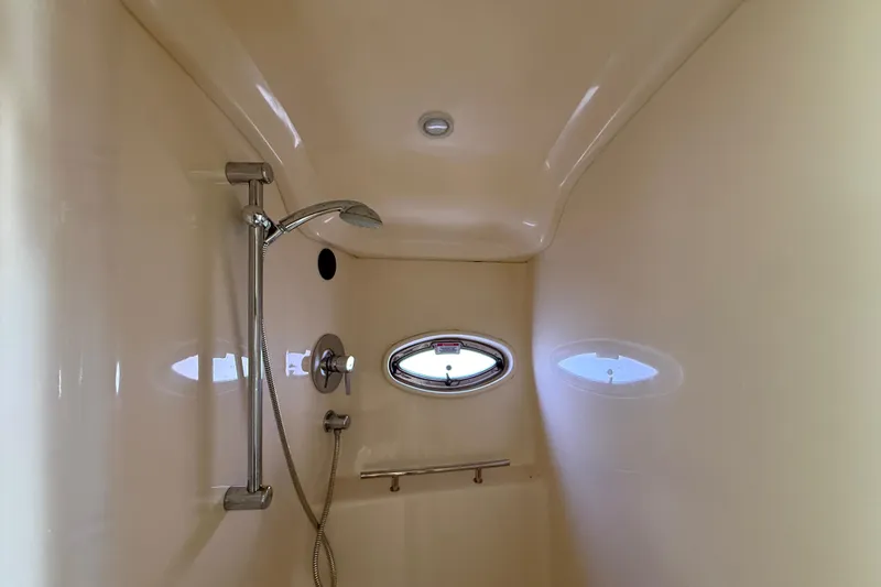 Slide: The Image of Shower area inside 2008 Sea Ray 38 Sundancer yacht, featuring sleek design and porthole window. - 58