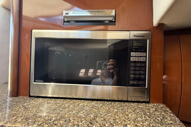Slide: The Image of Panasonic microwave in 2008 Sea Ray 38 Sundancer yacht kitchen, with wood cabinetry. - 71
