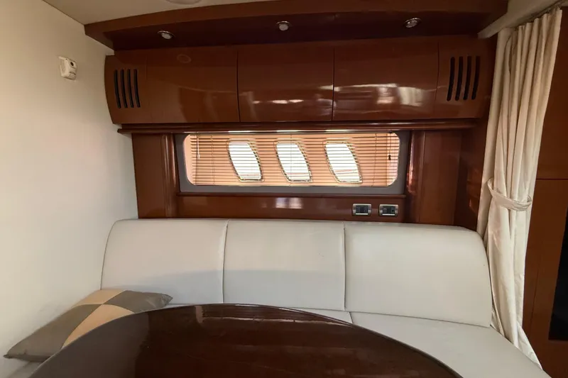 Slide: The Image of Interior of 2008 Sea Ray 38 Sundancer with elegant seating and wooden cabinetry. - 74