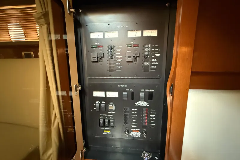 Slide: The Image of Electrical control panel inside a 2008 Sea Ray 38 Sundancer yacht cabin. - 82