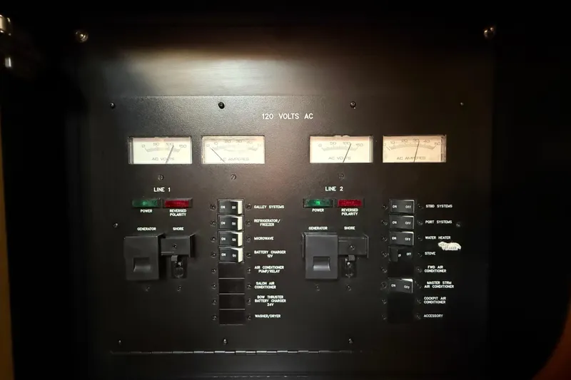 Slide: The Image of Electrical control panel of a 2008 Sea Ray 38 Sundancer boat, showing voltage and amperage meters. - 86