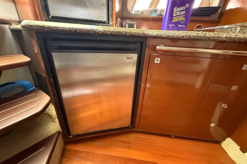 Slide: The Image of Interior of 2008 Sea Ray 38 Sundancer yacht with compact kitchen and stainless steel fridge. - 95