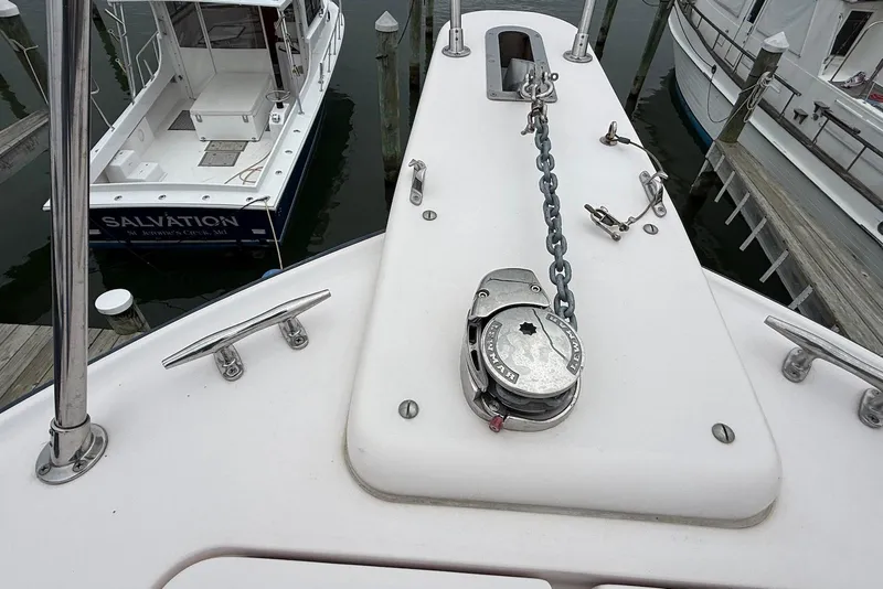 Slide: The Image of 2005 Grady-White Marlin 300 boat deck with anchor chain and winch at marina. - 10